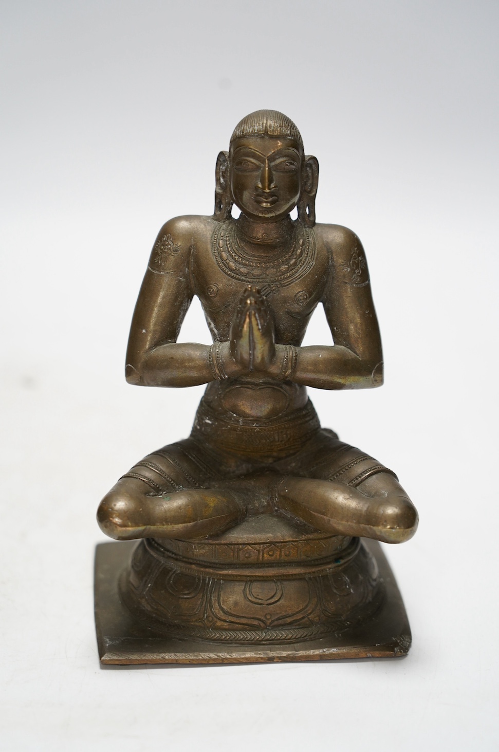 A Chinese bronze censer and cover, a Chinese bronze bowl and an Indian bronze seated deity, tallest 19cm high. Condition - fair some general scuffs and wear, the figure has a chip